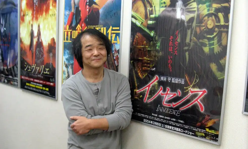 The director posing in front of posters for his films