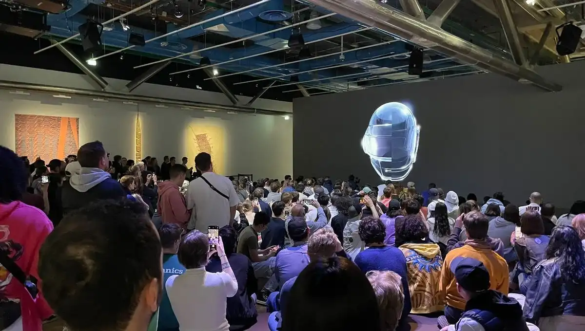 A group of people in front of a projection of Daft Punk